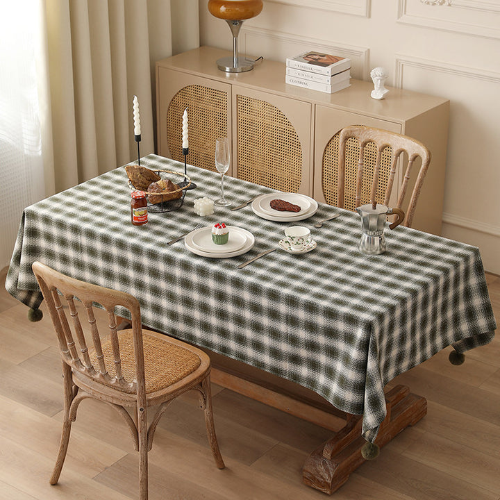 Rectangular checked tablecloth made of cotton blend with pom-pom corners
