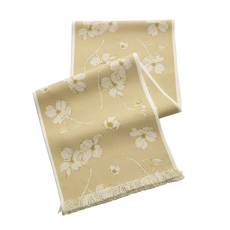 Woven botanical table runner with olive branch motif and fringed edge