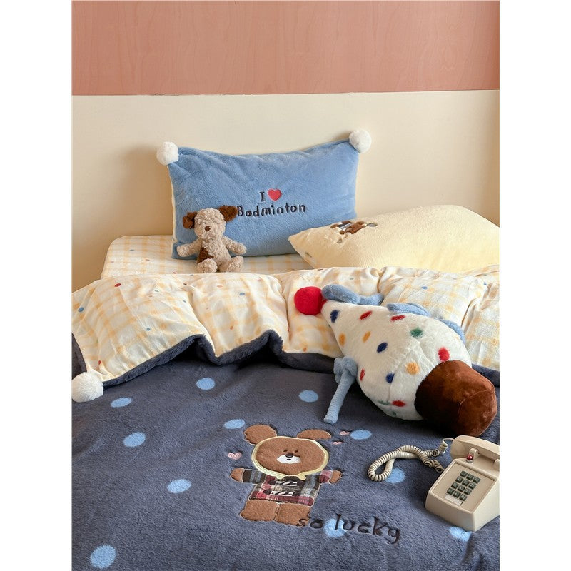 Plush bedspread with embroidered bear motif and pom-pom edge