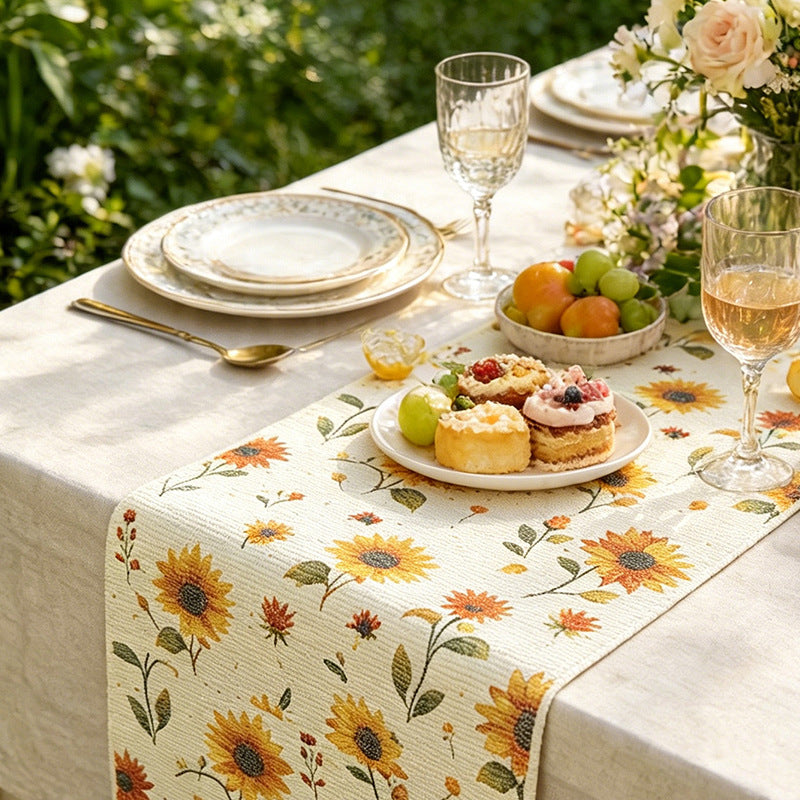 Woven table runner with floral embroidery and fringe trim