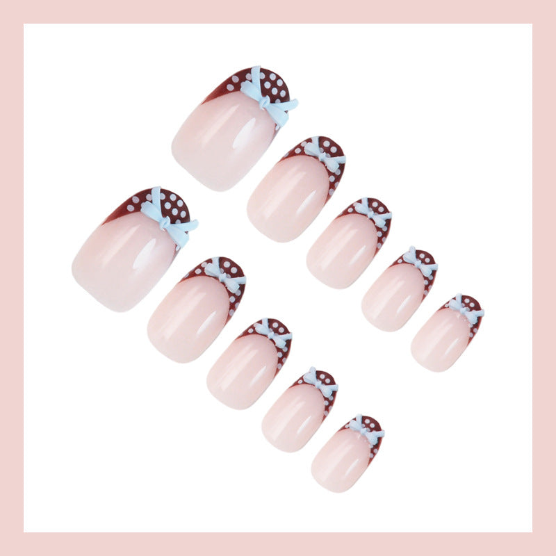 Artificial nail set with playful bows and elegant dots Kalsten