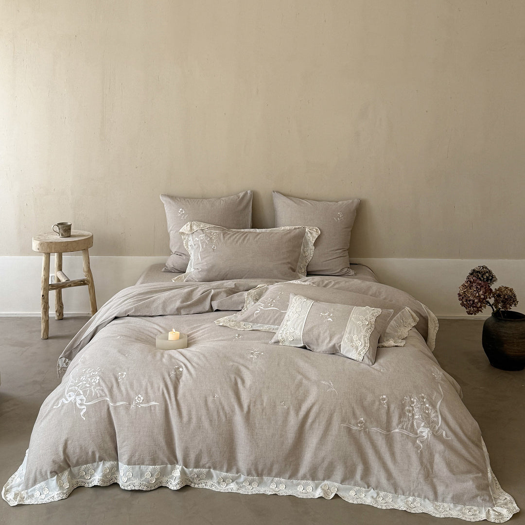 Vintage-inspired linen-cotton blend bedding set with floral chain stitch embroidery and lace trim