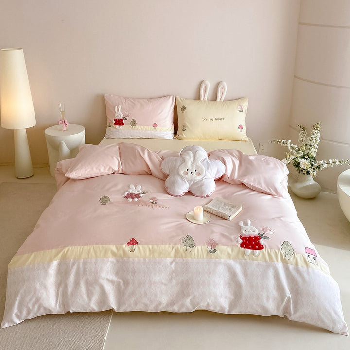 Playful cotton satin bed linen set with embroidered bunny appliqués and plush pillow