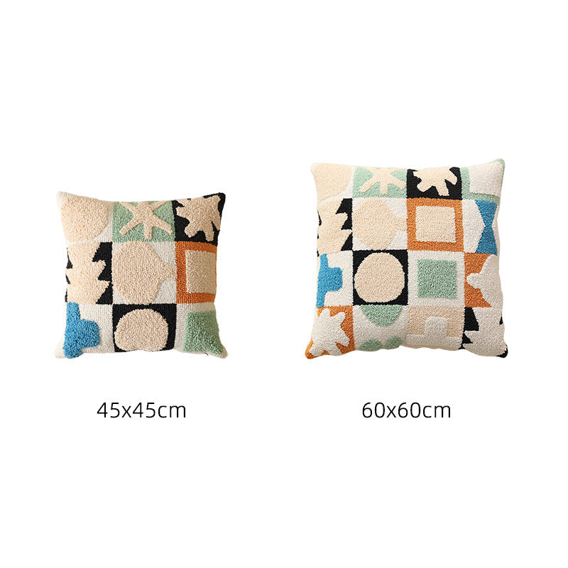 Hand-tufted decorative cushion with abstract graphic design and textured cotton surface