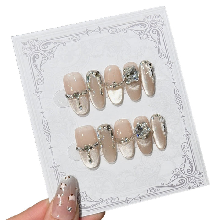 Glamorous nail tips with rhinestone and glitter effects Kalsten