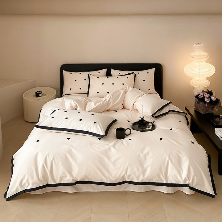 High-quality cotton satin bedding set with delicate embroidery, reversible feature & piping edge