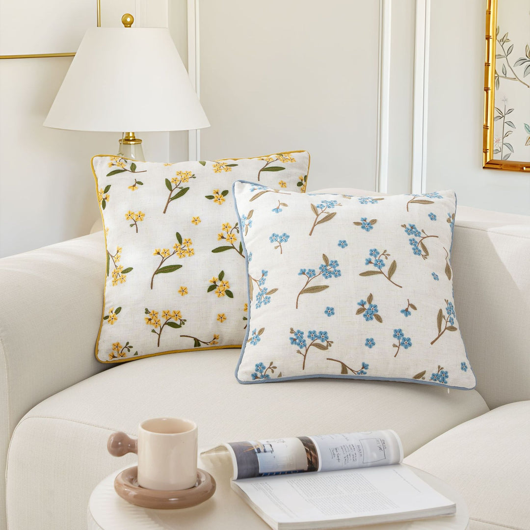 Embroidered linen decorative pillow with floral embroidery and piping