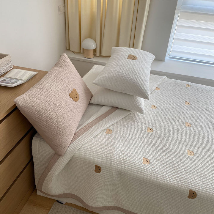 Padded quilt set with embroidered bear appliqués and neck roll