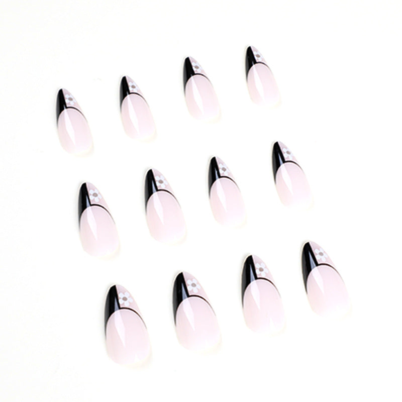 Artful nail art with elegant black-and-white design and floral accents Kalsten