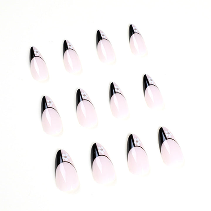 Artful nail art with elegant black-and-white design and floral accents Kalsten