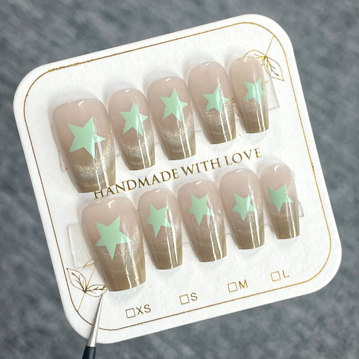 Artificial nail extensions with shimmer effect and star motifs Kalsten