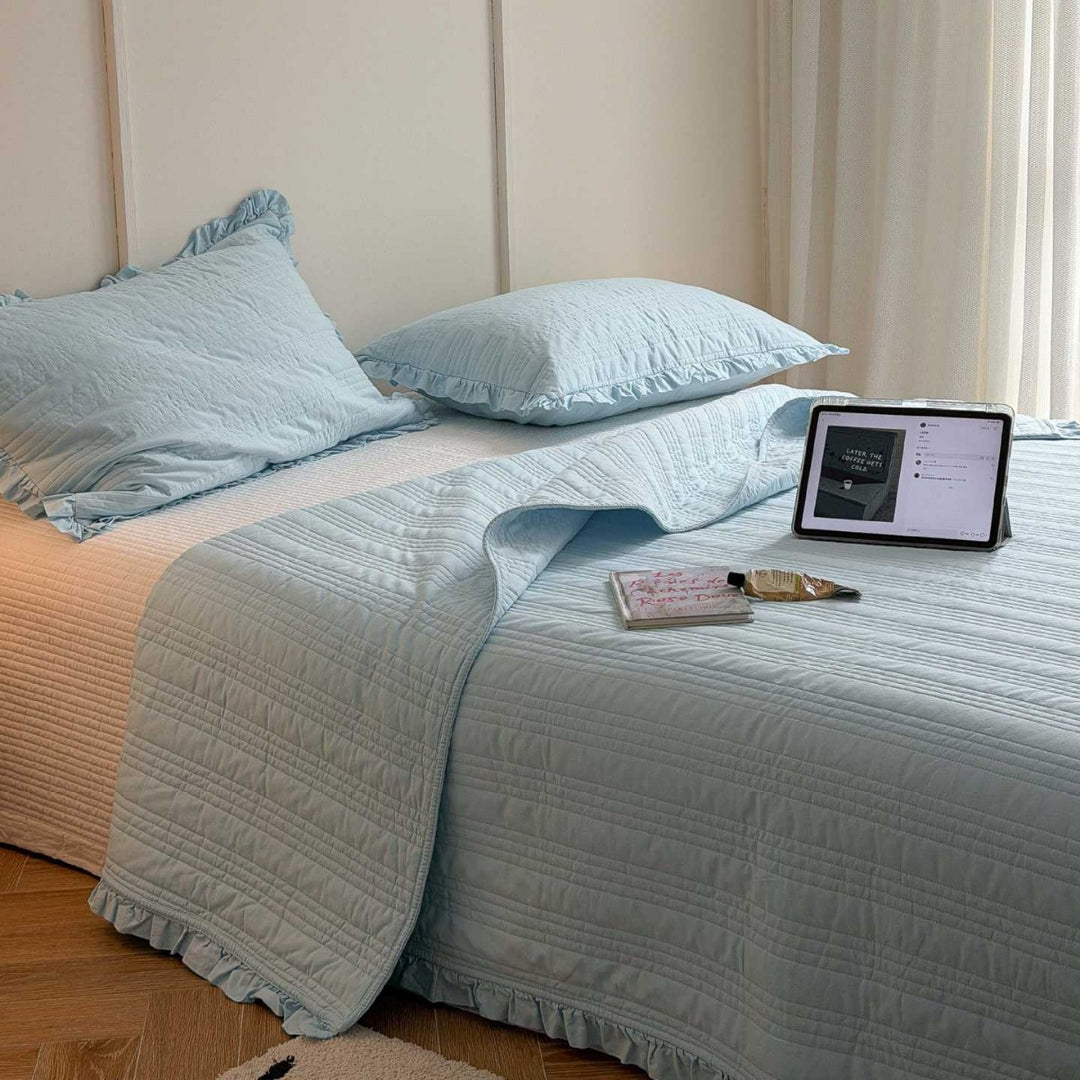 Quilted bedspread with frill and fine line quilting made of cotton blend fabric
