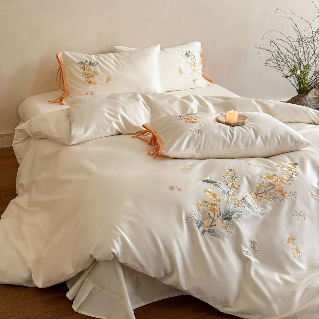 Luxurious satin bedding set with floral embroidery and bow appliqué