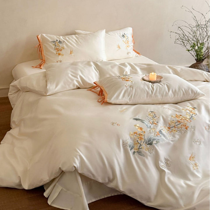 Luxurious satin bedding set with floral embroidery and bow appliqué