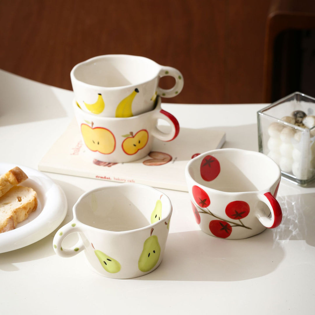 Ceramic mug with hand-painted banana illustration and round handle