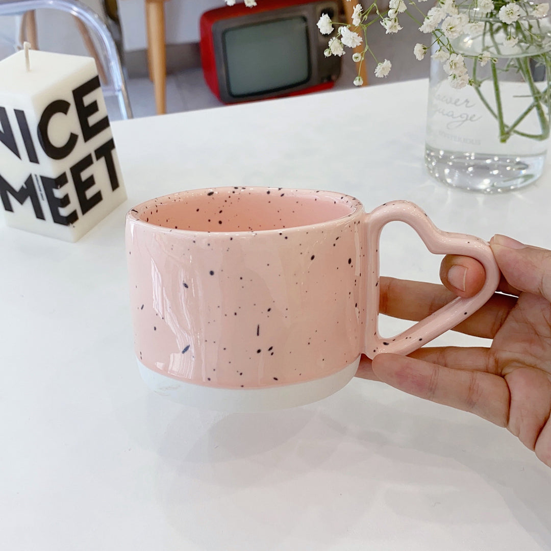 Oversized ceramic mug with heart-shaped handle and dotted glaze