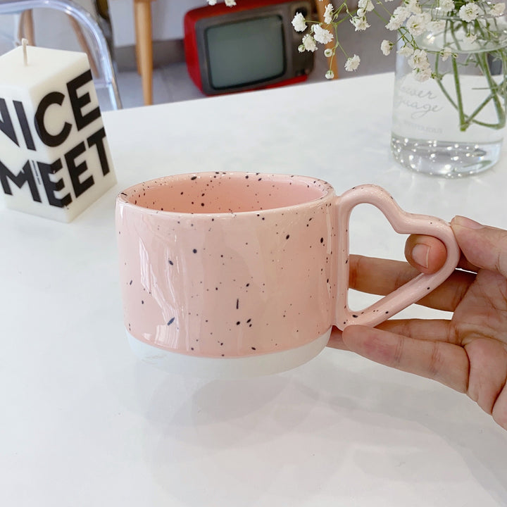 Oversized ceramic mug with heart-shaped handle and dotted glaze