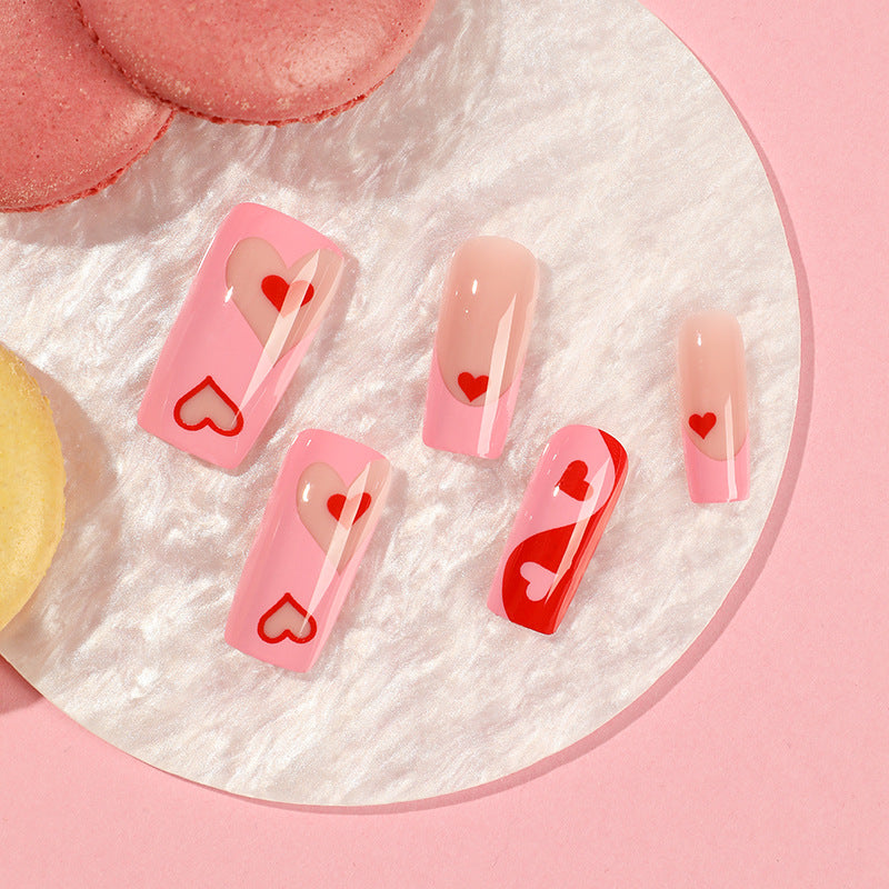 Artificial nail art with heart design and glitter accents Kalsten