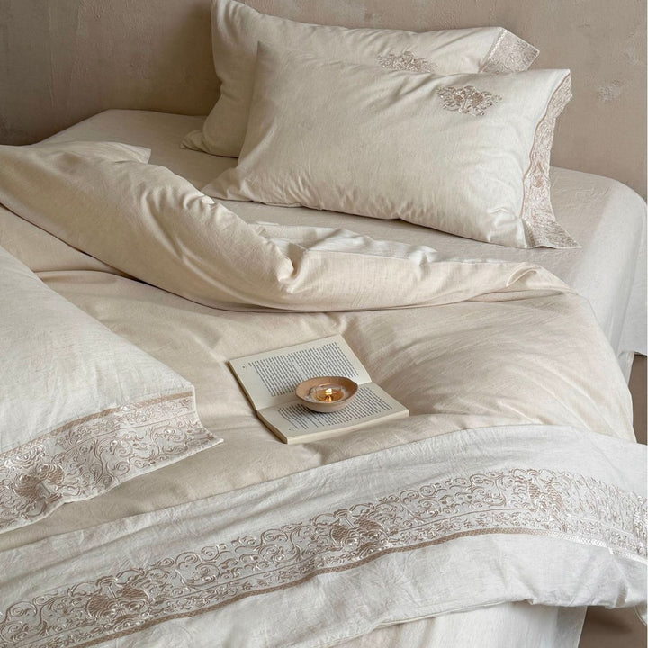 Fine linen bed linen set with floral tone-on-tone embroidery and hem detail