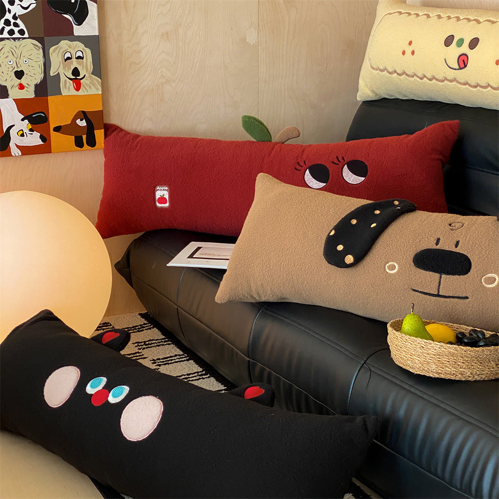 Extra-long plush sofa cushion with appliqués and plush feet