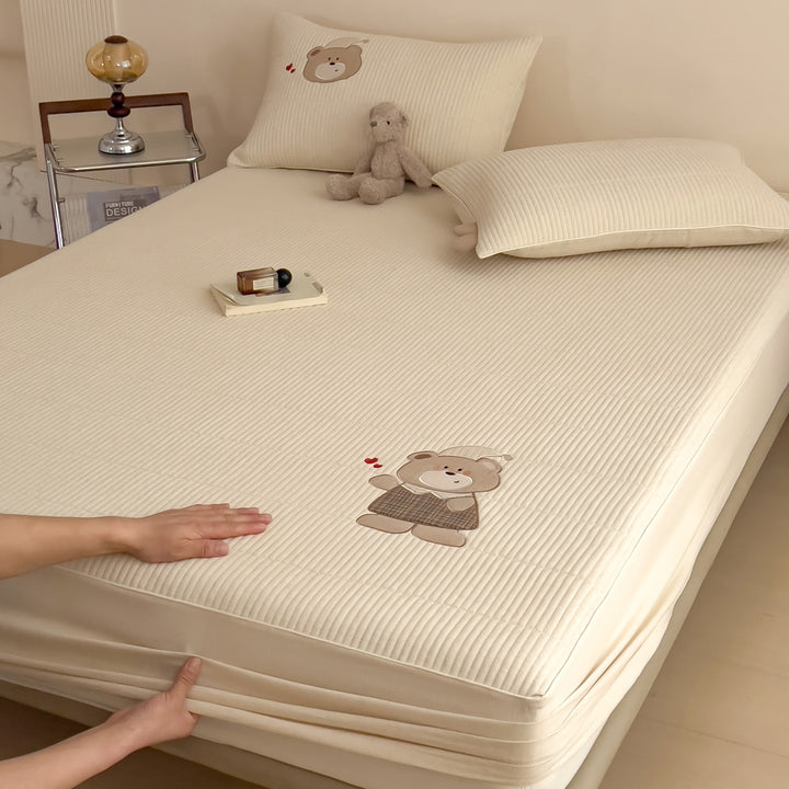 Quilted mattress topper with bunny applique and non-slip bottom