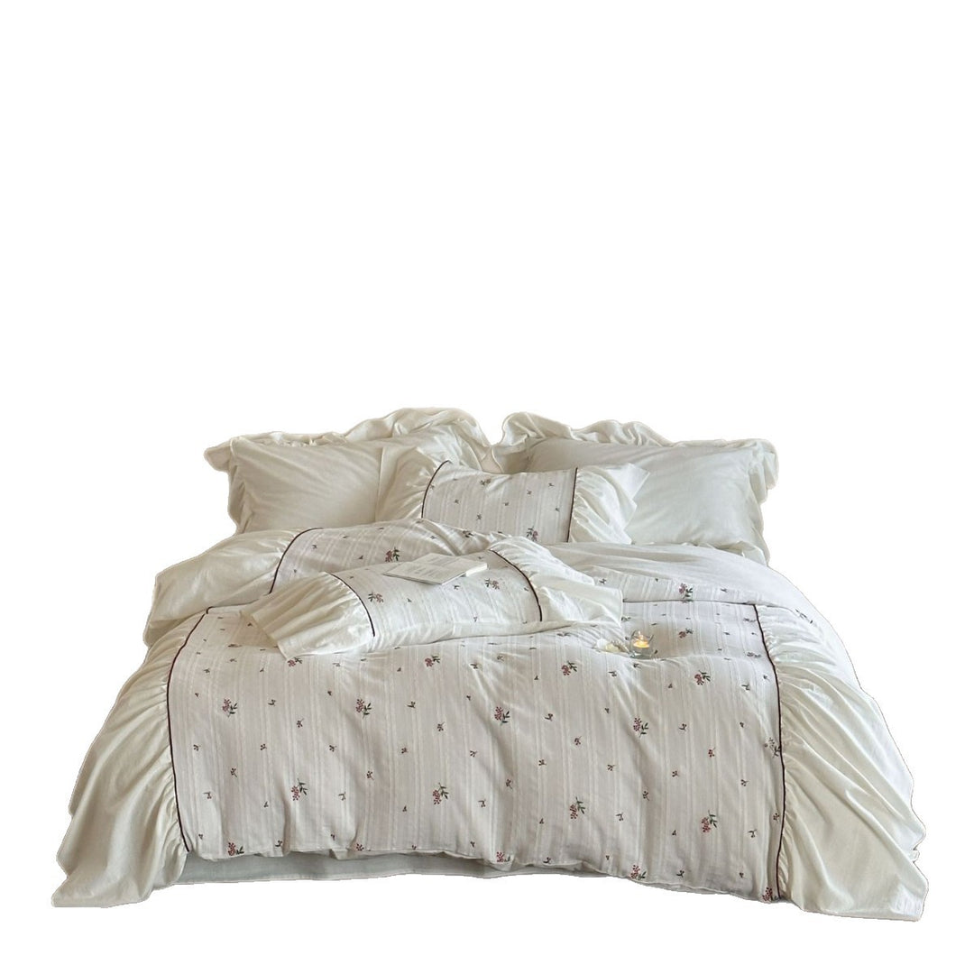 Romantic bed linen set made of cotton satin with ruffles, relief stripes, and contrasting piping