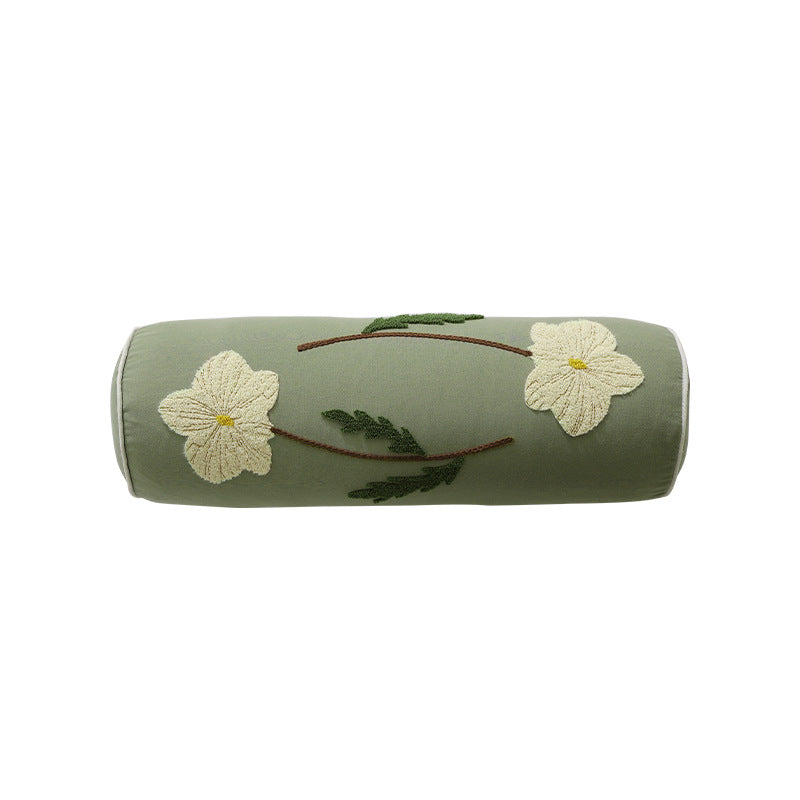 Bolster pillow with hand-stitched floral motif and decorative piping
