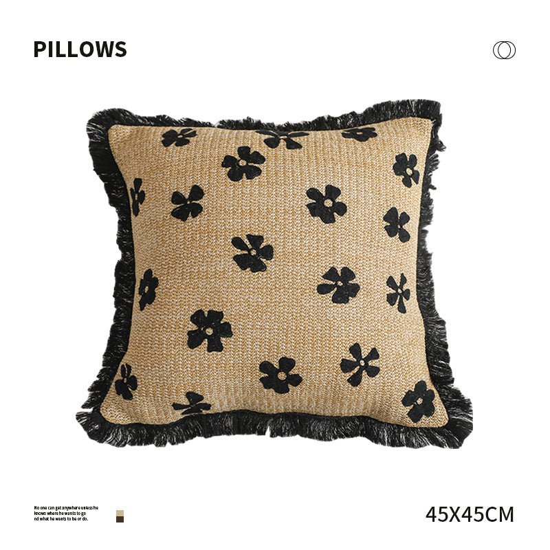 Rectangular woven decorative pillow with contrasting flower tufting and fringe trim