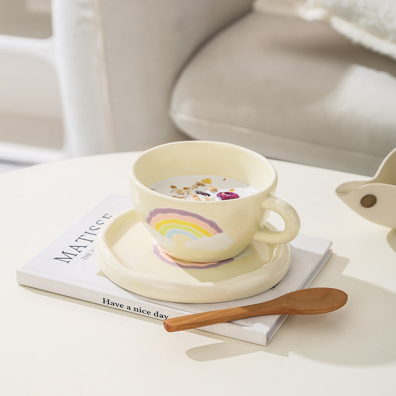 Stoneware breakfast mug with saucer and embossed rainbow design