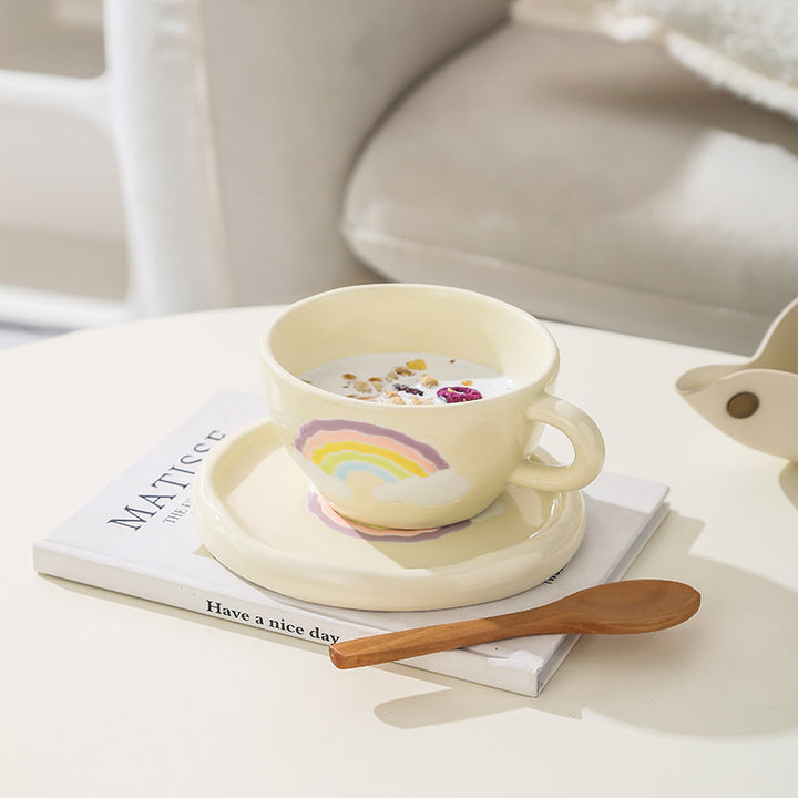 Stoneware breakfast mug with saucer and embossed rainbow design
