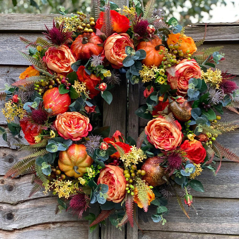 Autumn wreath with artistic roses, mini pumpkins, and eucalyptus branches