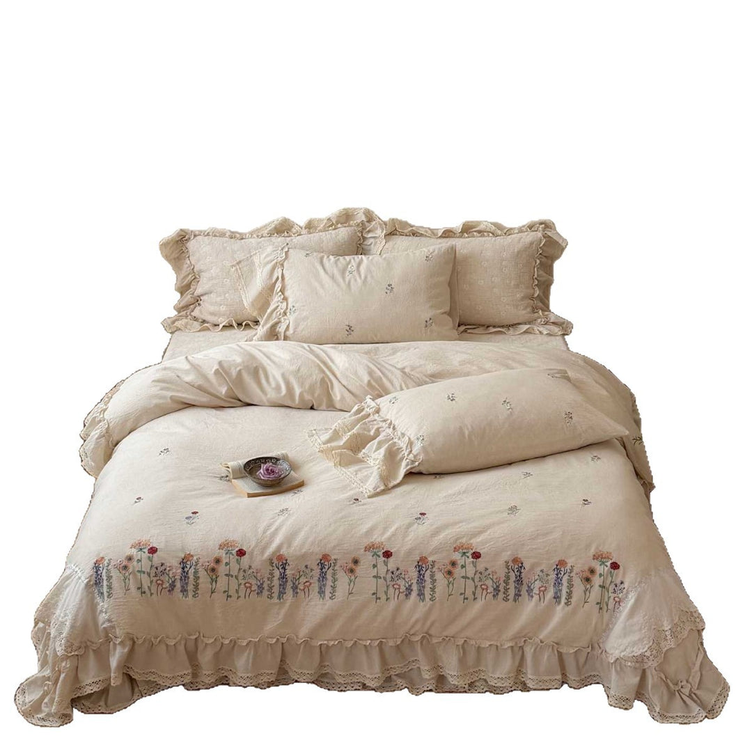 Romantic linen-cotton bedding set with embroidered floral border and ruffle