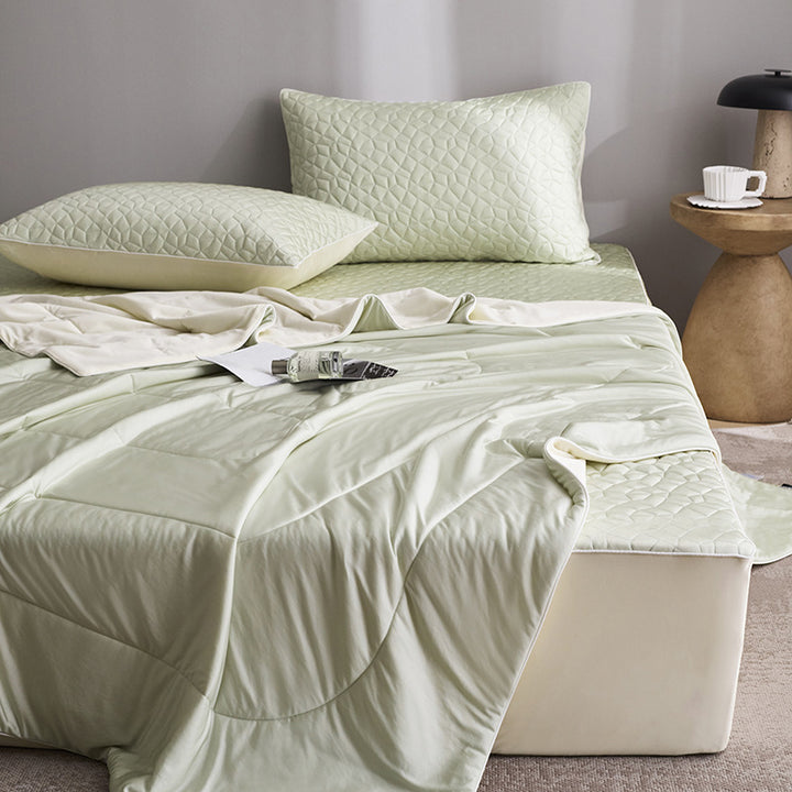 Quilted bedding set with reversible satin blanket and mattress protector