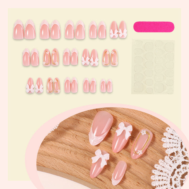 Artificial nail set with playful bow accents and delicate embellishments Kalsten