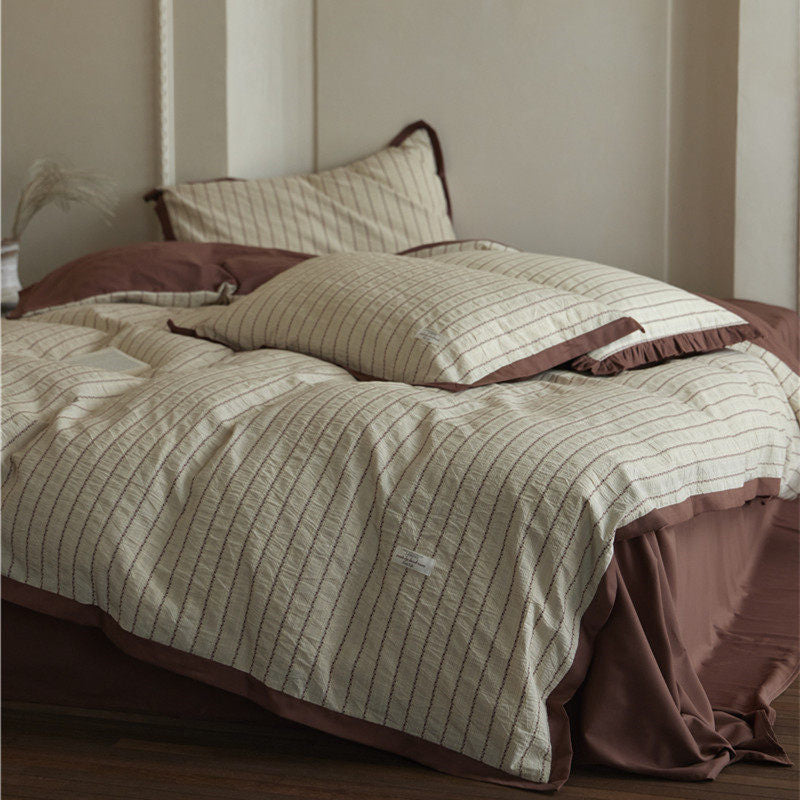 Bedding set with fine striped texture, ruffled border and breathable cotton blend