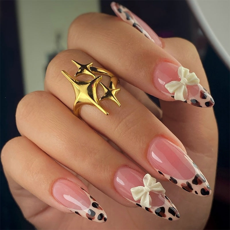 Artificial nail set with elegant leopard design and playful bow accents Kalsten