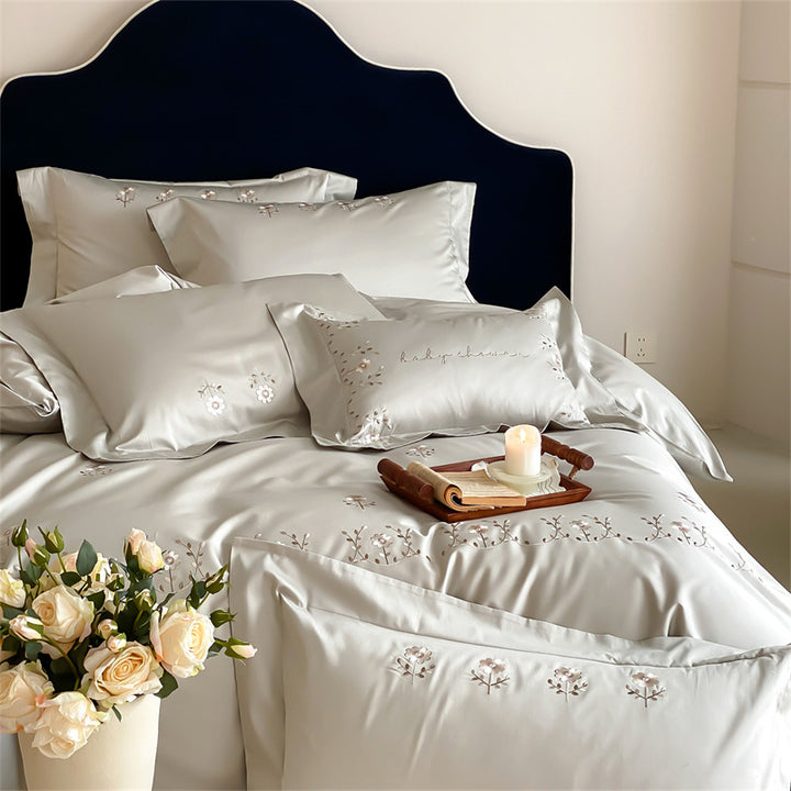 Satin bedding set with delicate flower embroidery and silk-soft touch