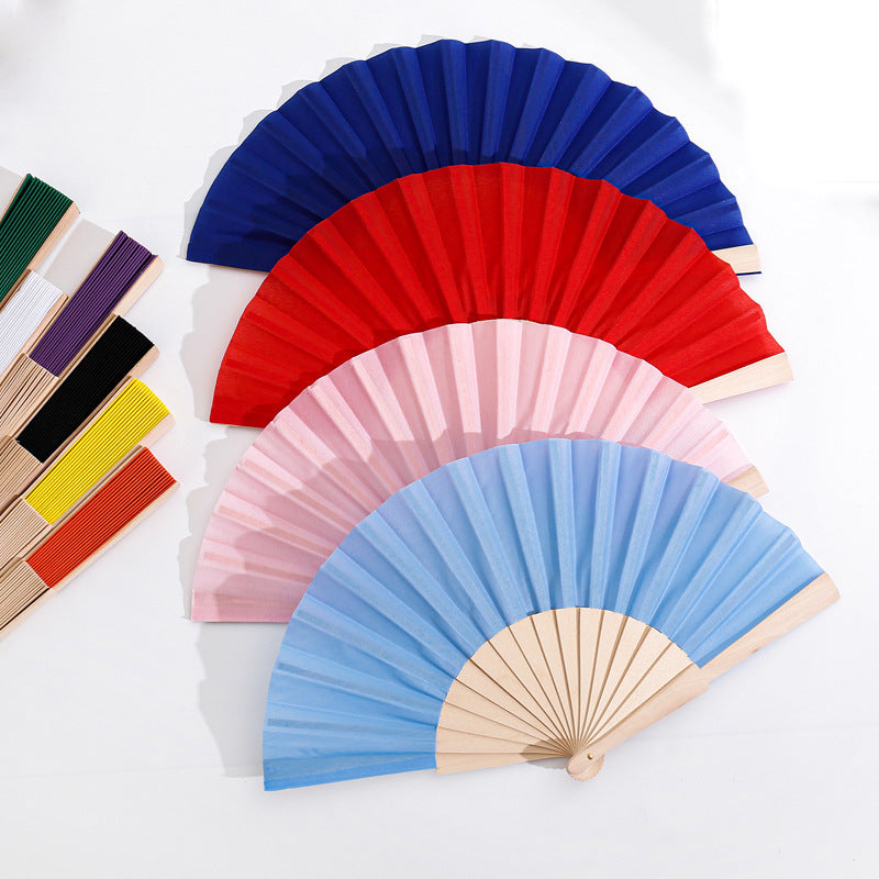 Ladies folding hand fan made of airy material with intricate folds Kalsten