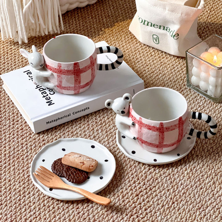 Playful ceramic cup set with koala relief handle and matching saucer