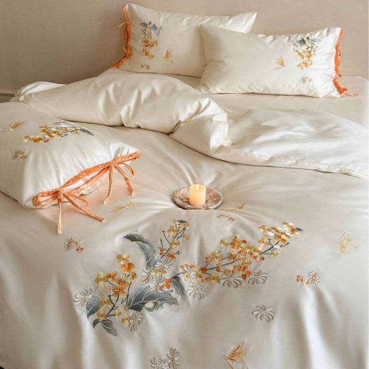 Luxurious satin bedding set with floral embroidery and bow appliqué