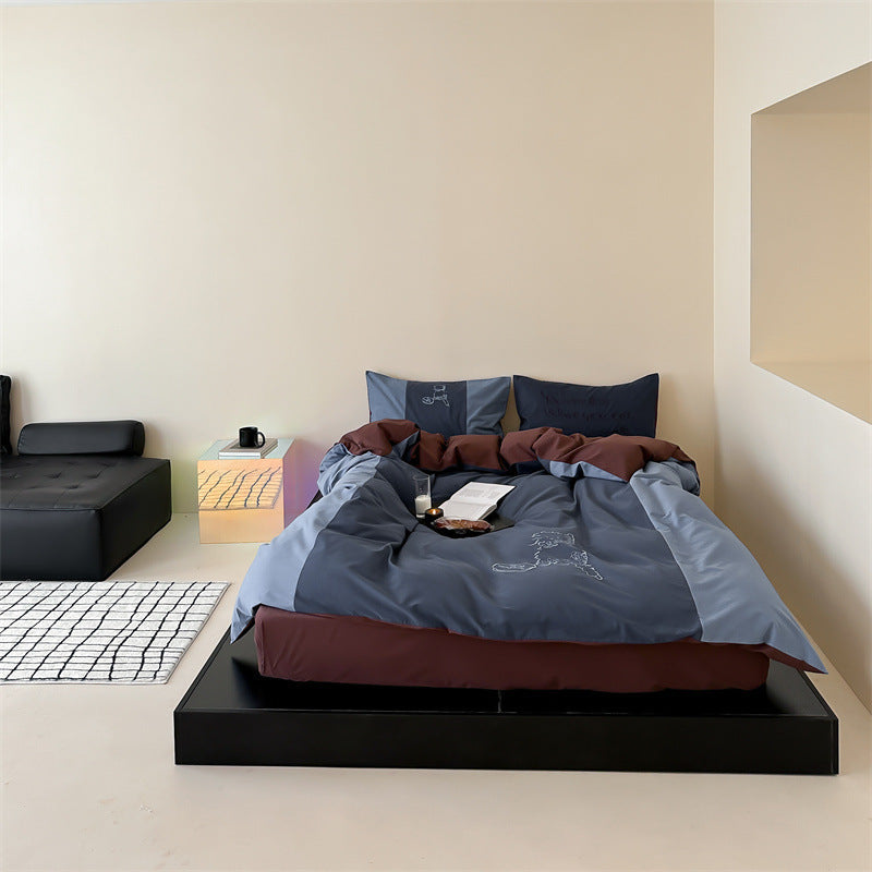 Reversible bedding set with contrasting inserts and fine line embroidery
