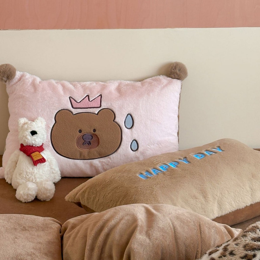 Striped plush throw blanket with decorative pom poms and appliqués