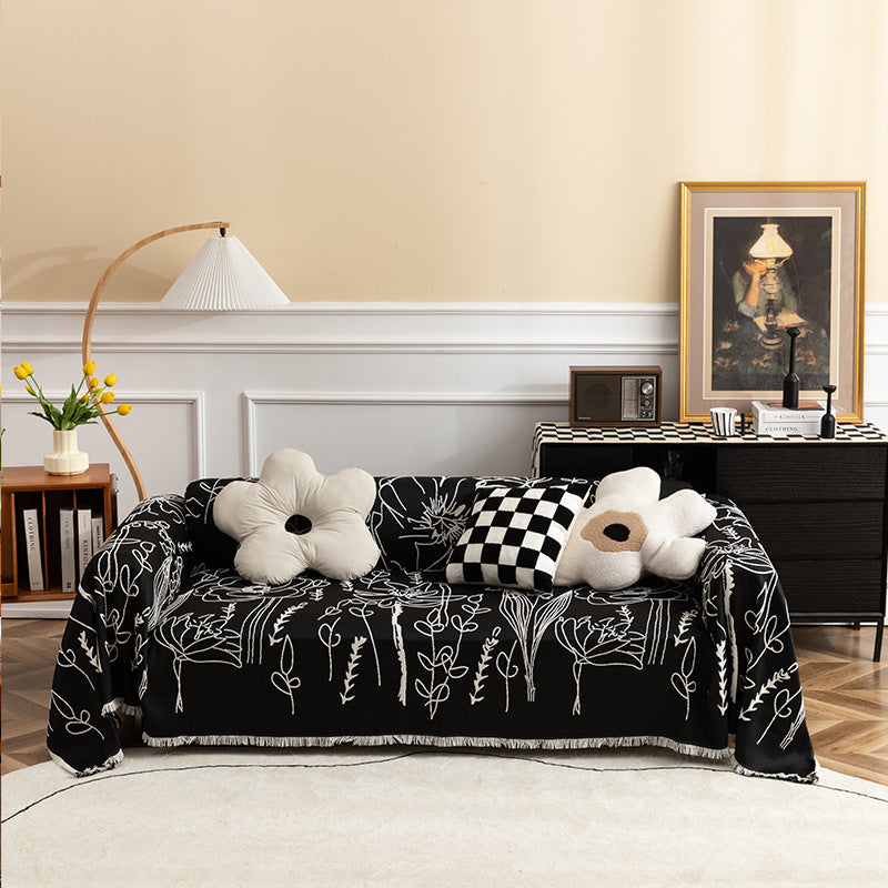 Light woven sofa cover with botanical line print and fringe hem
