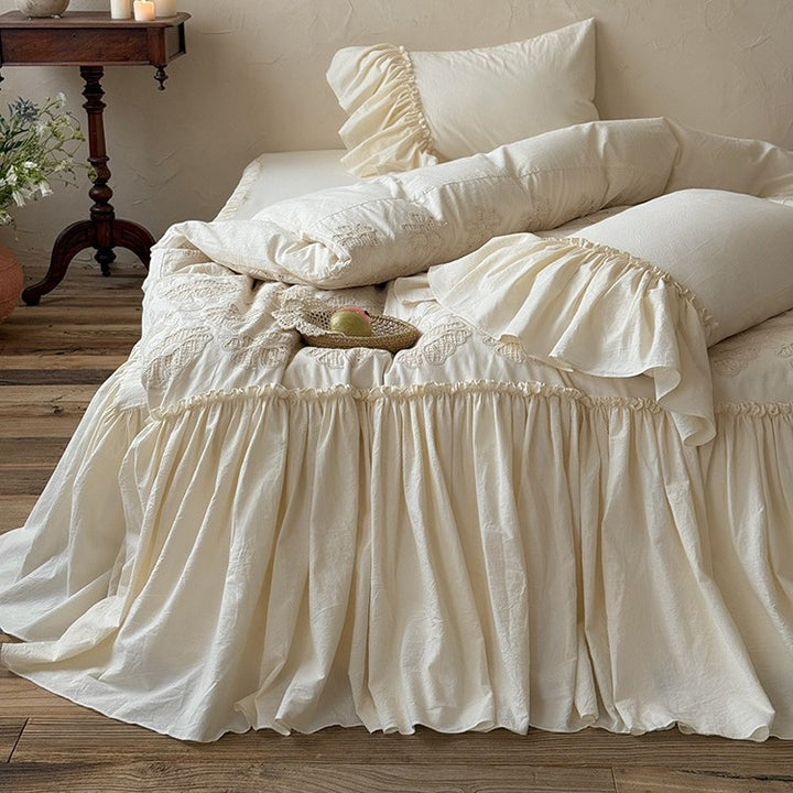 Vintage-inspired bed skirt and bedspread with wide ruffle and delicate embroidery