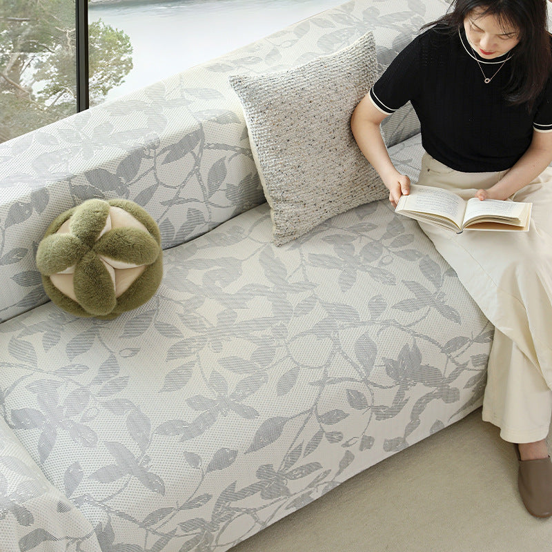 Universal sofa cover with floral relief and elastic hem