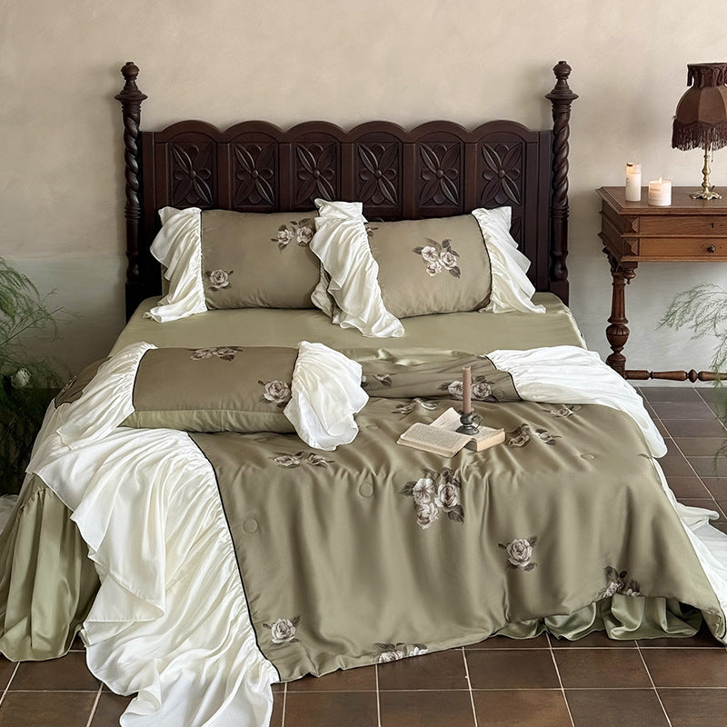 Romantic cotton satin bedding set with ruffled bed skirt and embroidered rose appliqués