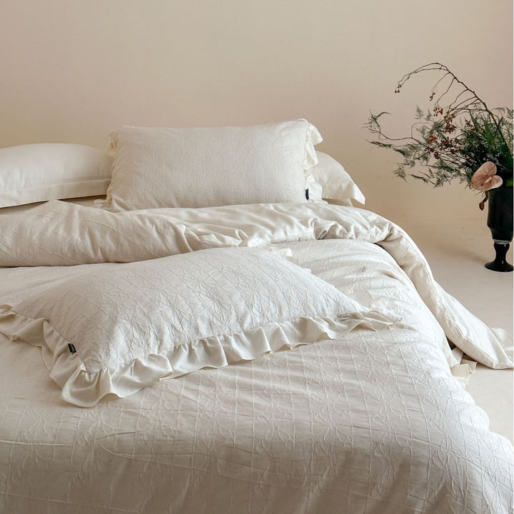 Quilted cotton-linen duvet cover set with subtle wrinkled texture and ruffle