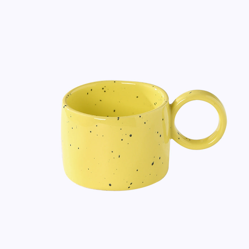Ceramic mug with heart-shaped handle and speckle design