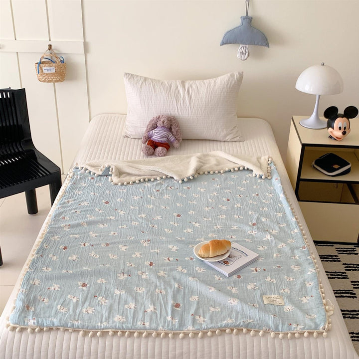 Children's Wende cuddly blanket made of cotton muslin with pompom border