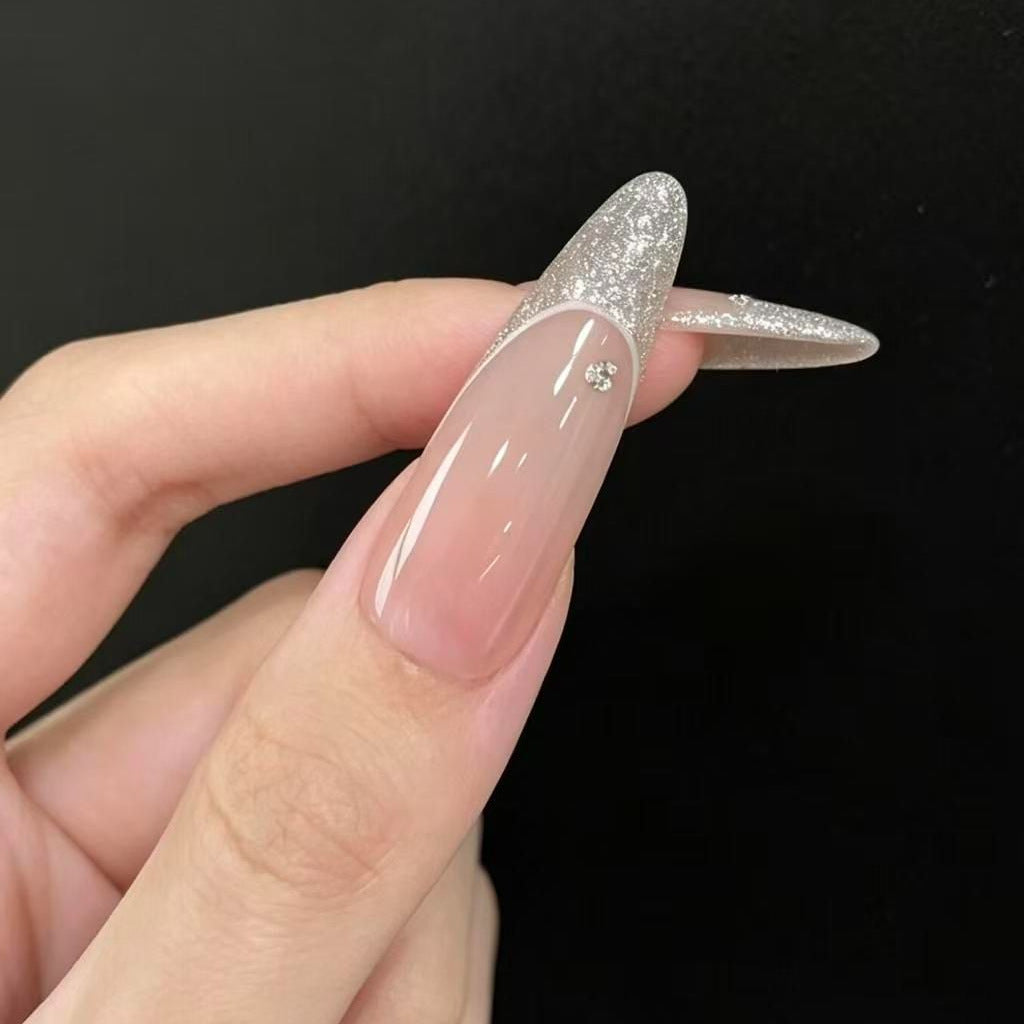 Stiletto Nail Enhancements with Glitter and Star Accents
